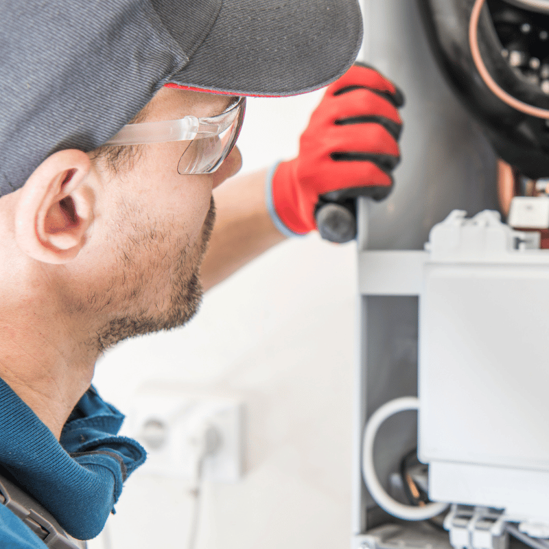 Service technician inspecting equipment during repair in Abilene TX
